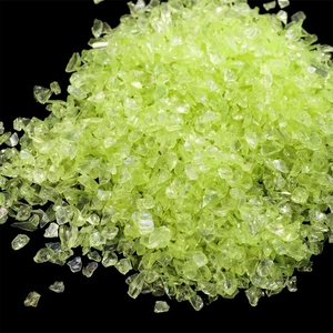 Macro shot of light green iridescent irregular glass shards for DIY nail art and fillers