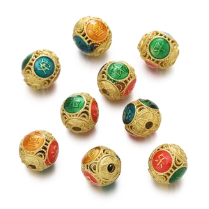 Detailed macro of golden cloisonne enamel hollow beads with auspicious Chinese characters