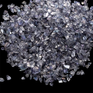 Macro shot of iridescent purple and grey crushed glass stones for DIY crafts