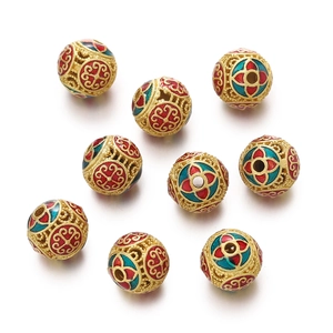 Macro shot of 9 hollow cloisonné beads with colorful floral enamel and golden finish