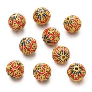 Detail of gold hollow cloisonné beads with red and blue enamel for DIY jewelry making