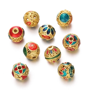 Detailed macro view of 9 golden hollow enamel cloisonne beads with traditional patterns