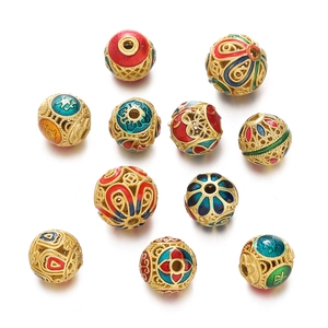 Macro detail of hollow cloisonné enamel beads with traditional gold filigree patterns