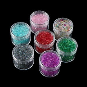 Detailed top view of mixed size iridescent glass bubble beads in seven colorful sets