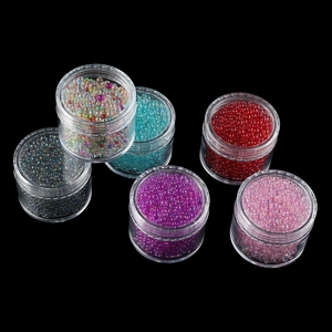 Macro shot of 6 jars of iridescent micro glass beads for nail art and DIY crafts