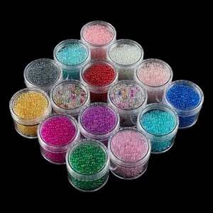 Detailed macro view of thirteen jars with colorful mixed glass bubble beads for DIY crafts