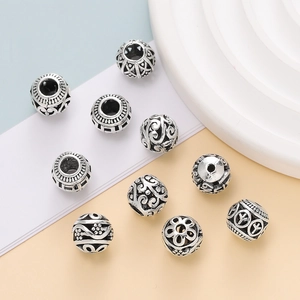Detailed view of assorted retro silver hollow charms for DIY jewelry crafting
