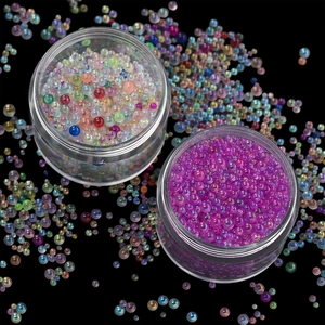 Macro shot of colorful glass micro beads in plastic jars for nail art and DIY resin crafts