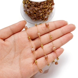 Macro view of faceted natural stone and gold bead chain for DIY jewelry making