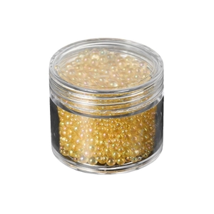Jar of iridescent yellow glass caviar beads for nail art and DIY resin crafts fillers