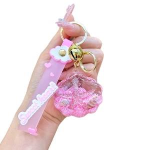 Pink shell liquid keychain with sea stars and glitter on a pink wrist strap