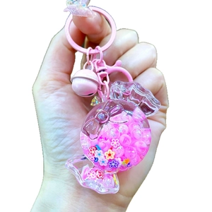 Pink macaron candy liquid quicksand keychain with luminous sequins and small bell charm