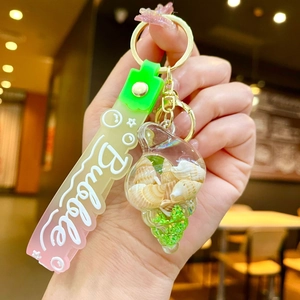Conch shell keychain with pink gradient silicone strap and golden metal clasp