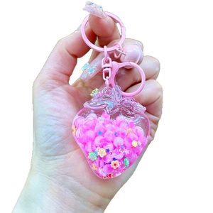 Kawaii pink strawberry keychain with liquid oil, glowing beads and metal clasp