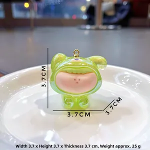 Macro shot of 3.7cm green translucent cartoon figure with gold ring for DIY craft