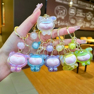 Detailed macro view of colorful translucent acrylic animal keychains with glitter charms