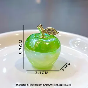 Close-up of a green apple keychain with golden leaf and sparkling crystals, 3.7cm height