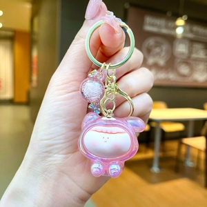 Macro view of pink translucent resin animal charm with iridescent glitter and gold hardware