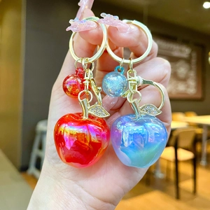 Creative apple keychains in red and blue gradient resin with sparkling rhinestone leaves
