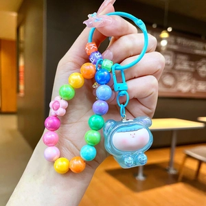 Detail of colorful rainbow beads with letters and a cute resin bear mascot on a phone chain