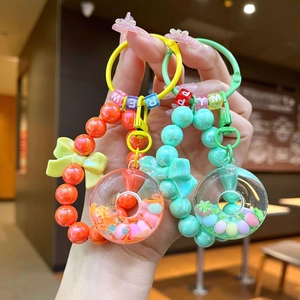 Colorful beaded donut keychain with bow charms and letter beads in vibrant colors