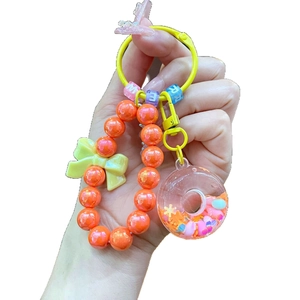 Handheld donut beaded keychain with colorful acrylic letters and yellow bow charm