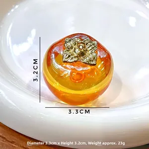 Detailed close-up of a persimmon charm showing 3.3cm diameter and 3.2cm height scale