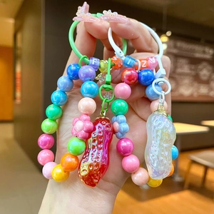 Porte-clés perles colorées avec pendentifs cacahuète et perles alphabet en tons macaron