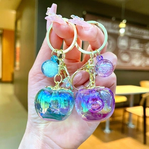 Cute apple-shaped laser rainbow charms with golden keychains in blue and pink resin