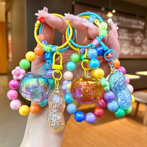 Cute persimmon and peanut beaded keychain with colorful acrylic charms and key ring