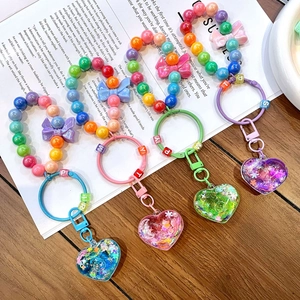 Colorful luminous beaded heart keychains with rainbow beads and glitter liquid charms