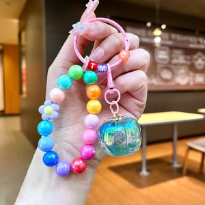 Macro view of colorful beaded keychain featuring a translucent crystal apple charm