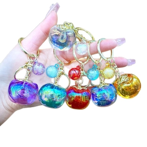 Colorful translucent apple-shaped keychain with shiny golden clip and gradient resin finish