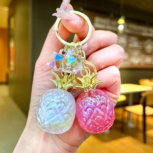 DIY colorful pearlescent pineapple keychains with golden leaves and faceted geometric pendants