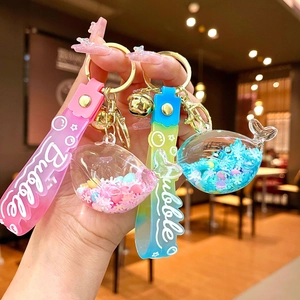 Glow-in-the-dark whale drifting bottle keychain with colorful sequins and silicone strap