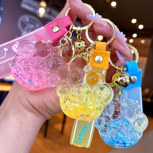 Porte-clés patte de chat lumineux avec sable mouvant et lanières en silicone colorées