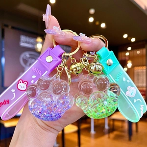 Porte-clés patte de chat lumineux avec paillettes mouvantes et bracelet en silicone