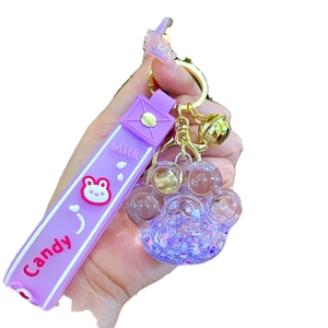 Porte-clés patte de chat lumineux avec paillettes violettes et sangle en silicone