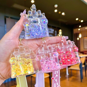 Sparkly liquid glitter castle keychains in pink, purple, and yellow with star sequins
