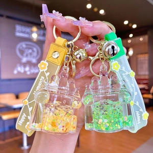 Close-up of castle-shaped liquid glitter keychains with stars and Happy Moments straps