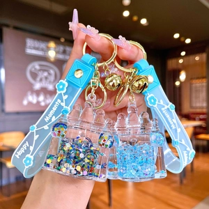 Luminous castle liquid keychain with blue wrist strap and gold bell accessory