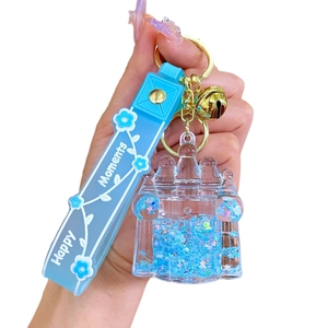 Blue oil-filled castle keychain with stars, golden bell and silicone handle strap