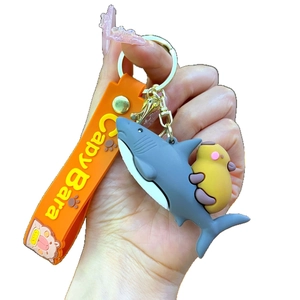 Cute Capybara with shark costume keychain featuring orange silicone strap and gold metal hook
