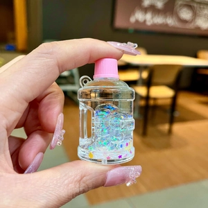 Glow-in-the-dark acrylic liquid bucket liquid keychain with colorful sequins and sand