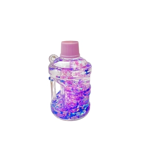 Mini bucket liquid keychain with pink flowing sand, glitter stars, and acrylic finish