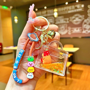 Cute Capybara liquid quicksand keychain with pink silicone wristband and golden bell