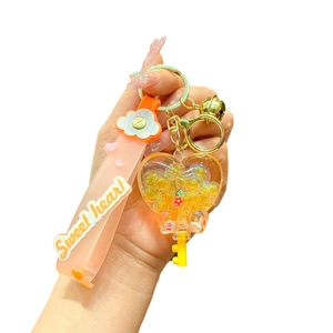 Luminous heart keychain with yellow glitter oil, sweet heart strap and golden bell charm