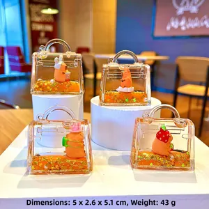 Detail view of four Capybara liquid quicksand bag charms with diverse cute headwear