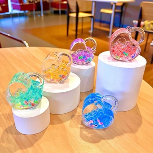 Colorful heart-shaped acrylic floating sand charms with luminous beads and floral sequins