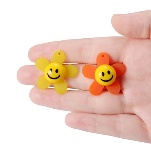 DIY acrylic sunflower pendants with smiley faces in yellow and orange colors